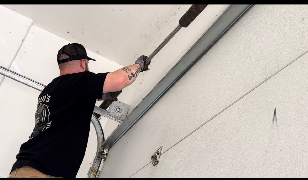 Winding a torsion spring shaft above a garage door