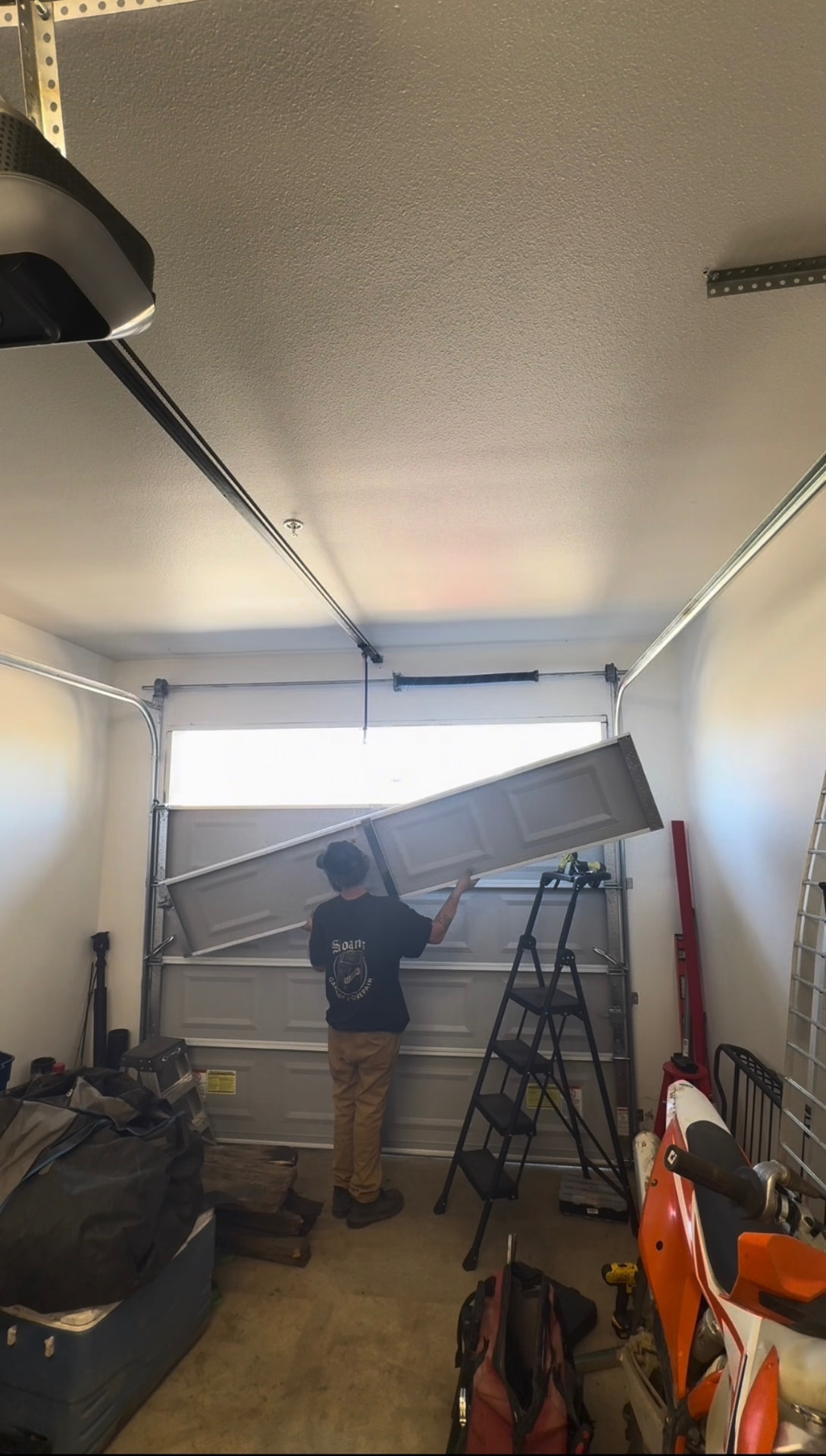 Setting a replacement door section into the track